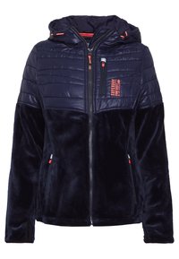Navy blue takki, jossa on tilkkupintainen huppu ja olkapäät, pehmeä samettikangas, edessä vetoketju, vetoketjullinen rintatasku ja sivutaskut, Superdry-logo rinnassa.