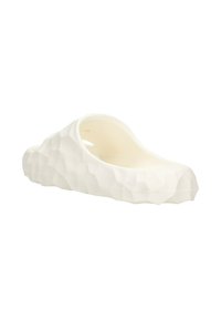 White slip-on shoe with a textured, faceted surface. Made from flexible material, featuring an open back and smooth inner lining.
