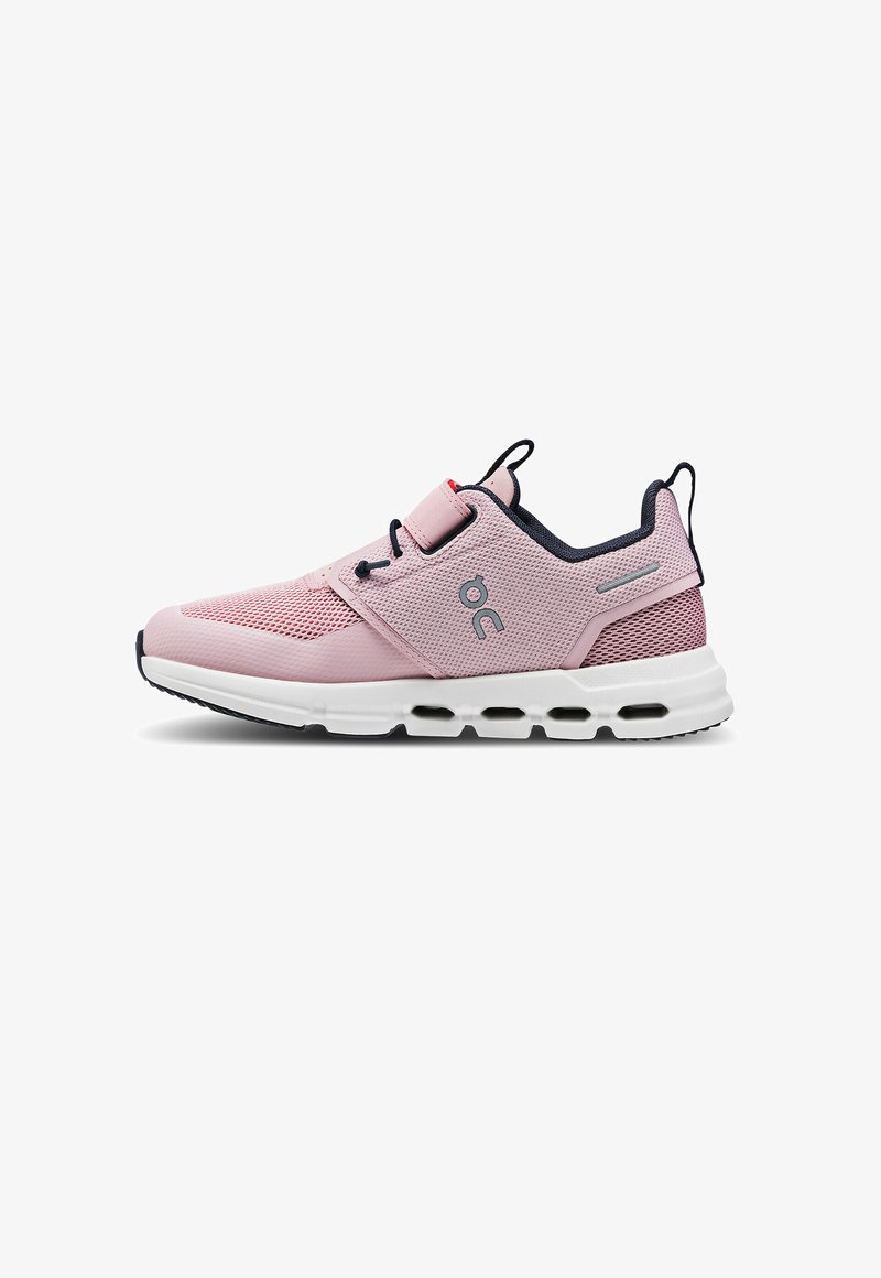Light pink athletic shoe with a mesh upper, contrasting navy accents, elastic laces, padded collar, and a white cushioned sole.