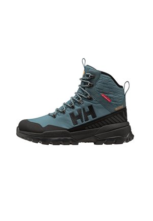 Hiking boot in teal and black, featuring a textured upper, sturdy rubber sole, reinforced toe, and prominent branding on the side.