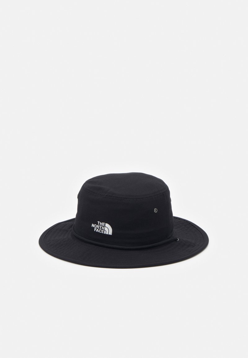 Black bucket hat made of fabric with a wide brim, featuring a white logo embroidery on the side and metal eyelet for ventilation.