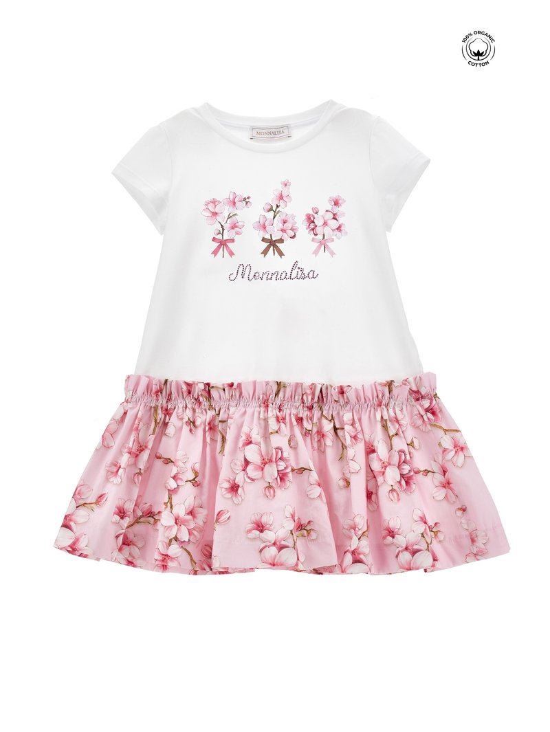 Haut en coton blanc à manches courtes avec imprimé floral et texte "Monnalisa". Jupe rose à ourlet volanté, ornée d'un motif floral.