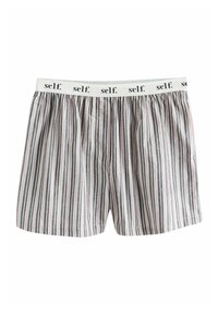 Calzoncillos bóxer de algodón ligero para hombre con rayas verticales en negro y blanco y cintura elástica blanca con la palabra "self." impresa.