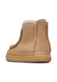 Stivaletti alla caviglia in suede color tan con una morbida fodera interna, suola in gomma testurizzata e dettagli di cucitura minimi. Entrata laterale senza hardware visibile.