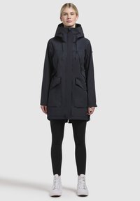 Navy waterproof parka with a hood, front zipper, two large pockets, and adjustable waist. Features a smooth texture and a knee-length design.