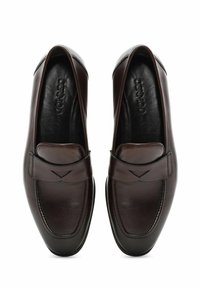 Mocassins en cuir marron avec un embout arrondi, des détails de couture et une sangle décorative avec une découpe. Surface lisse et intérieur rembourré.