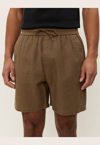 Pantalones cortos de lino marrón con cintura elástica y detalle de cordón. Tienen un ajuste relajado y una superficie texturizada.
