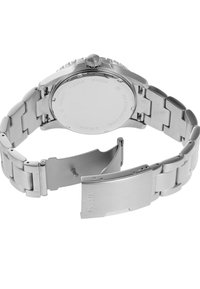Montre en acier inoxydable avec une finition polie, bracelet en métal, fermoir sécurisé et logo de la marque gravé au dos du boîtier. Forme ronde, design minimaliste.