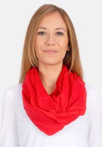 Red, lightweight, textured infinity scarf draped around the neck. Soft fabric with a slight sheen, creating gentle folds and a rich color.