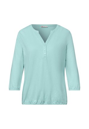 Chemise bleu clair à manches trois-quarts avec un col en V et trois boutons sur le devant, ourlet et poignets élastiques, de la marque Street One.
