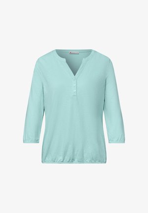 Chemise bleu clair à manches trois-quarts avec un col en V et trois boutons sur le devant, ourlet et poignets élastiques, de la marque Street One.