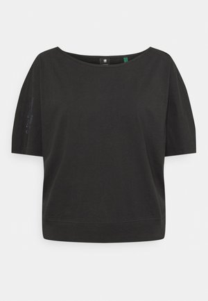 Black short-sleeve loose-fit top with wide round neckline and subtle text detail on left sleeve, displayed on white background.