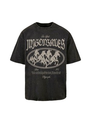 Zwart, oversized katoenen t-shirt met een ronde halslijn. Het shirt heeft een grote afbeelding van galopperende paarden in een lichtgrijze ovaal, met tekst erboven en eronder.