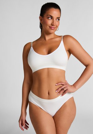 Witte naadloze bralette met dunne verstelbare bandjes en een bijpassende high-waisted slip. Gladde, rekbare stof met een minimalistisch ontwerp.