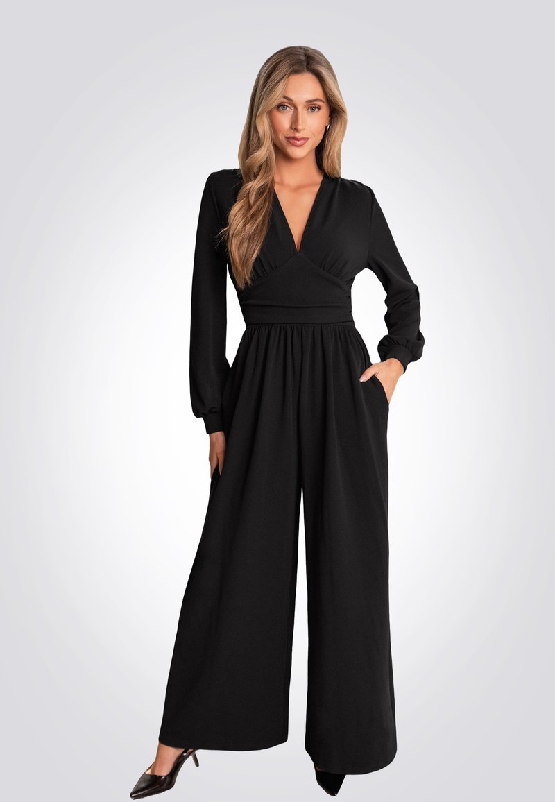 Combinaison noire à manches longues, décolleté en V, taille cintrée et design à jambes larges. Comprend des poches latérales et un tissu lisse et texturé.