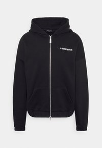 Sweatshirt à capuche noire en mélange de coton. Comprend une fermeture éclair à l'avant, des poches latérales et un texte logo blanc sur la poitrine. Texture douce.