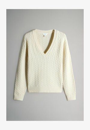 Cream-colored sweater with a V-neck, featuring cable knit texture, long sleeves, and ribbed cuffs and hem.