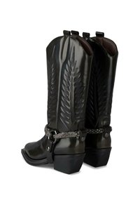 Botas de vaquero de cuero negro con puntera尖, costuras decorativas y un acento de cadena metálica en el tobillo. Diseño de tacón grueso.