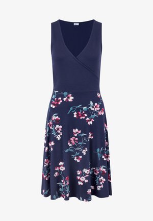 Mornarice plava cvjetna haljina s V-izrezom i bez rukava. Ima usko tijelo i lepršavu suknju, ukrašena uzorcima cvijeća u ružičastoj i tirkiznoj boji.