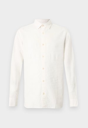 Chemise blanche à manches longues avec boutons, fabriquée en tissu léger. Présente un col pointu et une texture subtile avec des boutons contrastants.