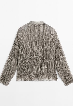 Schwarz-weiß kariertes Bluse mit strukturierter, geraffter Gestaltung, langen Ärmeln und abgerundetem Saum. Leichter, halbtransparenter Stoff.