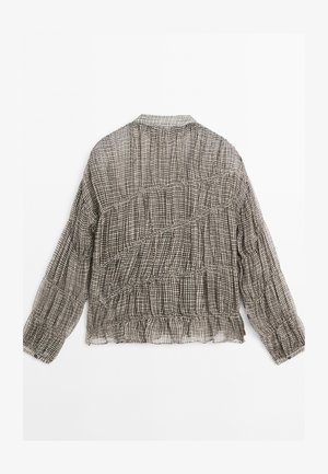 Schwarz-weiß kariertes Bluse mit strukturierter, geraffter Gestaltung, langen Ärmeln und abgerundetem Saum. Leichter, halbtransparenter Stoff.
