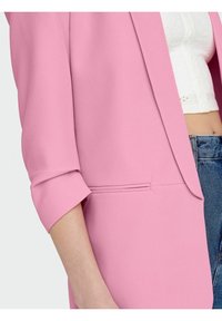 Blazer rosa con un design strutturato, caratterizzato da un colletto a cannello e maniche arrotolate. Include un dettaglio tasca sottile e una texture liscia.