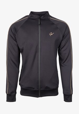 Melnas zip-up jakas, izgatavota no gludas auduma, ar zelta akcentiem uz pleciem un sānu kabatām ar rāvējslēdzējiem.