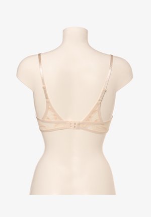Lace-back bra in nude, featuring thin adjustable straps, a hook-and-eye closure, and a floral pattern on a semi-sheer fabric.