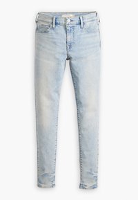 Jeans de denim azul claro con ajuste Slim, diseño de cinco bolsillos y un ligero desgastado. Cuenta con una cintura con botones y presillas para el cinturón.