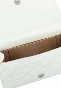 Borsa a tracolla bianca trapuntata realizzata in materiale sintetico, dotata di chiusura con bottone argento e fodera interna beige con logo impresso.