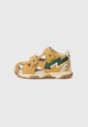 Yellow and green children's sandals featuring two adjustable Velcro straps, cutouts for ventilation, and a rubber sole with a textured finish.