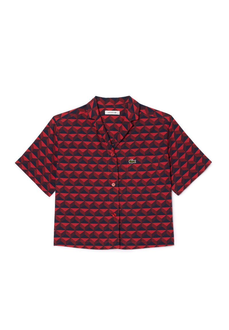 Kurzarmhemd mit geometrischem Muster in Rot und Marineblau. Hergestellt aus einem Stoff mit glatter Textur, enthält eine Tasche und ein Logo.