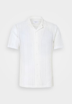 White short-sleeved shirt made of textured knit fabric. Features a camp collar, button closure, and vertical stripe pattern.