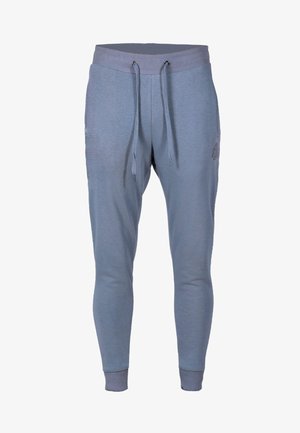 Lyseblå joggere lavet af blødt stof, med ribbet talje med snøre og tætsiddende manchetter ved anklerne, minimalistisk design.