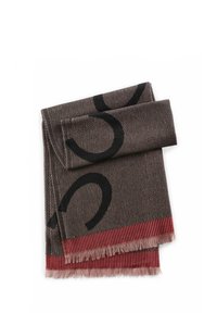 Tissu tissé de couleur marron avec un motif abstrait noir, doté d'une frange rayée rouge sur le bord. Texture douce et forme rectangulaire.