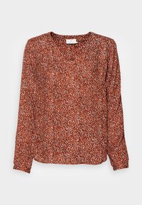 Blouse à manches longues couleur rouille avec un motif floral. Dotée d'un décolleté en V et d'un tissu léger et texturé. Détails en blanc et noir.