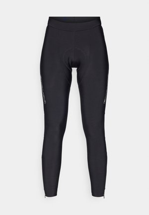 Leggings de cyclisme noirs au design ajusté, avec une zone de siège rembourrée et des zips latéraux au niveau des chevilles. Fabriqués en matériau lisse et extensible.