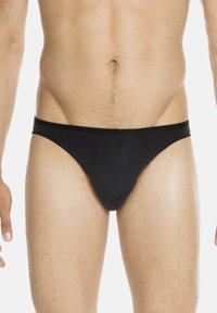 Black swim briefs made of smooth material, featuring a narrow waistband and a minimalistic design, with a snug fit around the hips.