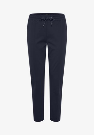 Tumesinised vöödiga ja nööriga meresinised dressipüksid. Omavad kitsenevaid jalgu ja sileda tekstuuri. Ilma nähtavate taskute või mustriteta.