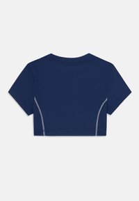 Camiseta cropped de color azul marino con mangas cortas, que presenta costuras blancas en contraste a lo largo de las costuras laterales y un escote redondo.
