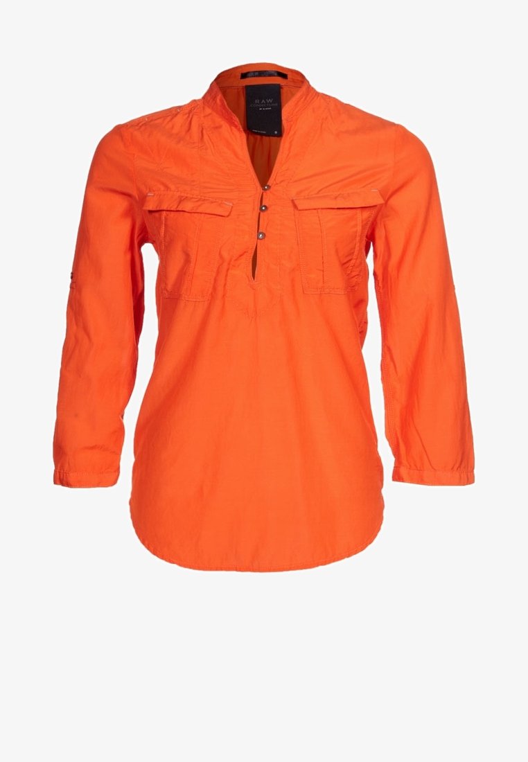 Chemise orange à manches longues en tissu léger, dotée d'une patte de boutonnage à demi, de deux poches poitrine et de détails froncés au niveau du col.