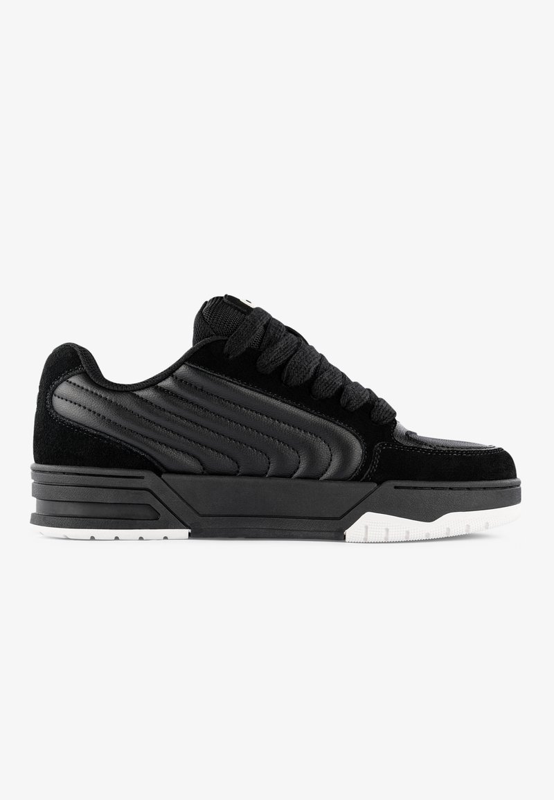 Black sneakers featuring a suede and synthetic leather upper, textured side panels, thick black laces, and white rubber sole.