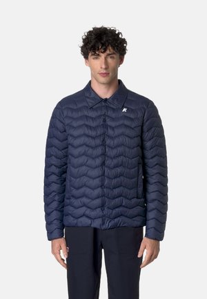 Giubbotto trapuntato blu navy con colletto a punta, chiusura a bottoni e un piccolo logo sul lato sinistro del petto. Superficie testurizzata con un design gonfiato.