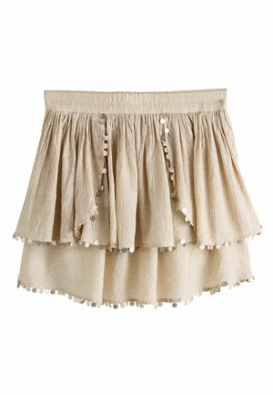 Beige lagdelt krøllet stofnederdel med elastisk talje og sølv palietkant langs kanterne.