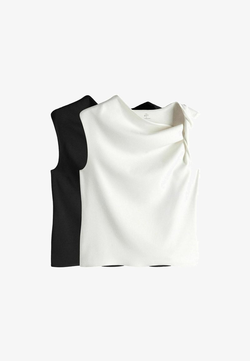 Tops sans manches noirs et blancs avec encolure bateau, superposés les uns derrière les autres sur fond blanc.