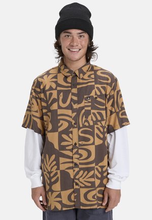Short-sleeve button-up shirt in brown and beige, featuring a bold, abstract leaf and snake pattern with a chest pocket and a logo emblem.