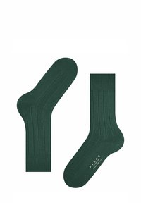 Calcetines de color verde oscuro con textura de canalé, fabricados con un material suave, que cuentan con puntera y talón reforzados, y texto de la marca en la suela.