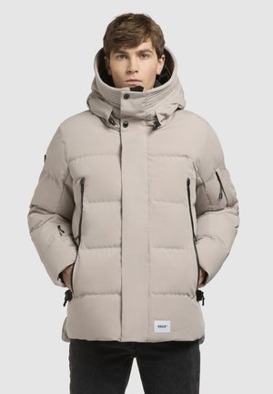 Beige gepolsterte Jacke mit hohem Kragen, Frontreißverschluss, verstellbarem Kapuzenzug und schwarzen Akzentreißverschlüssen; verfügt über ein logopatch am Saum.