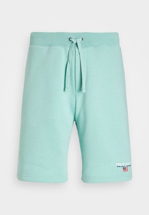 Light blue cotton shorts with an elastic waistband, drawstring closure, and logo detailing on the left leg. Smooth texture and tailored fit.